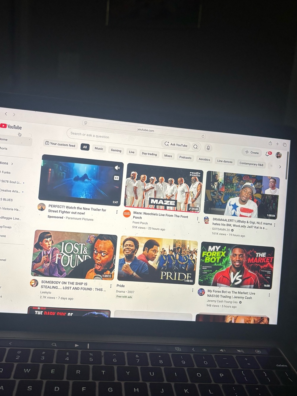 Apple Black Laptop Displaying YouTube Homepage
